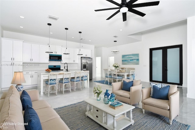 living area featuring visible vents, recessed lighting, french doors, and a ceiling fan