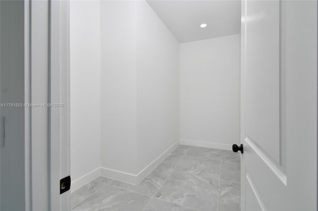 interior space with recessed lighting, marble finish floor, and baseboards