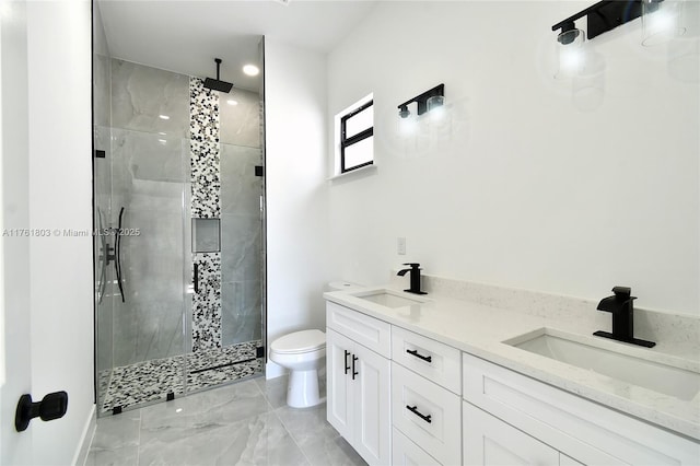 full bath with toilet, a stall shower, marble finish floor, and a sink