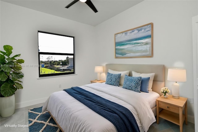 tiled bedroom featuring baseboards and ceiling fan