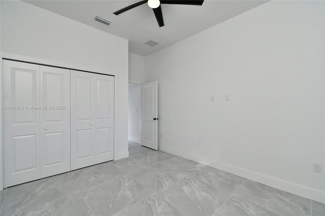 unfurnished bedroom featuring a closet, visible vents, marble finish floor, and baseboards