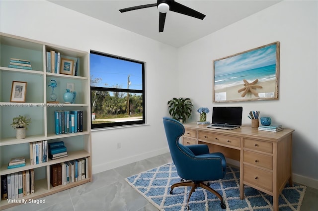 office space with a ceiling fan and baseboards