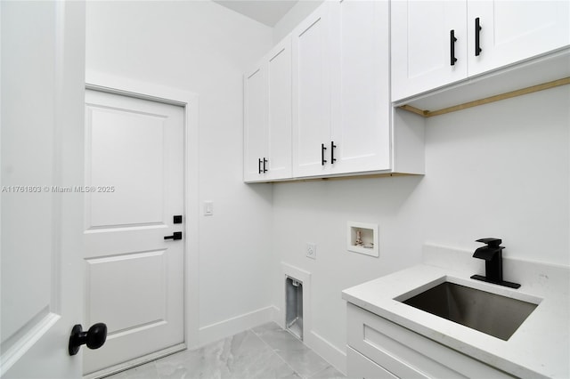 clothes washing area with washer hookup, cabinet space, hookup for an electric dryer, marble finish floor, and a sink