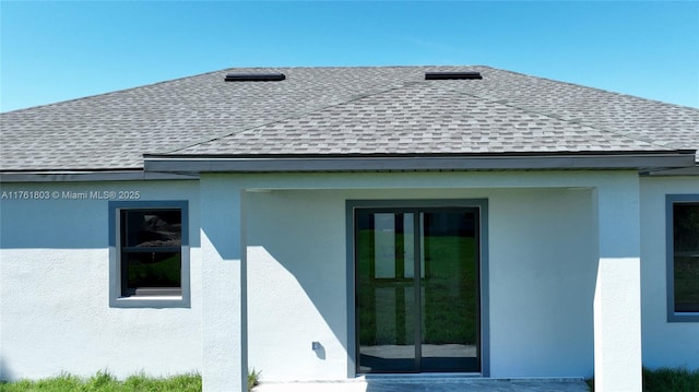 view of property exterior featuring stucco siding and a shingled roof