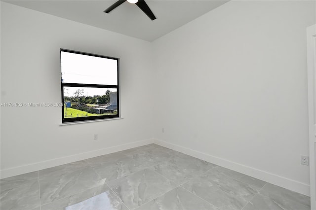 spare room featuring baseboards and ceiling fan