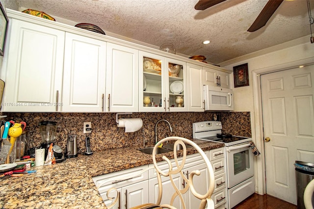 kitchen with white cabinetry, white appliances, backsplash, and a sink