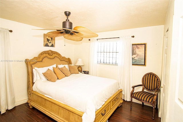 bedroom with a textured ceiling, dark wood-style floors, and ceiling fan