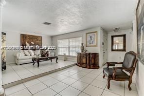 living area featuring tile patterned floors