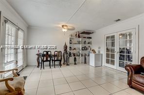 living room featuring tile patterned floors and french doors