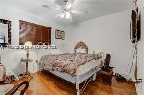 bedroom with ceiling fan and wood finished floors