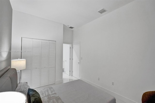 interior space with baseboards, visible vents, and a closet