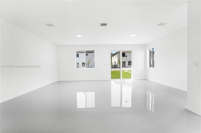 empty room featuring recessed lighting, visible vents, and baseboards