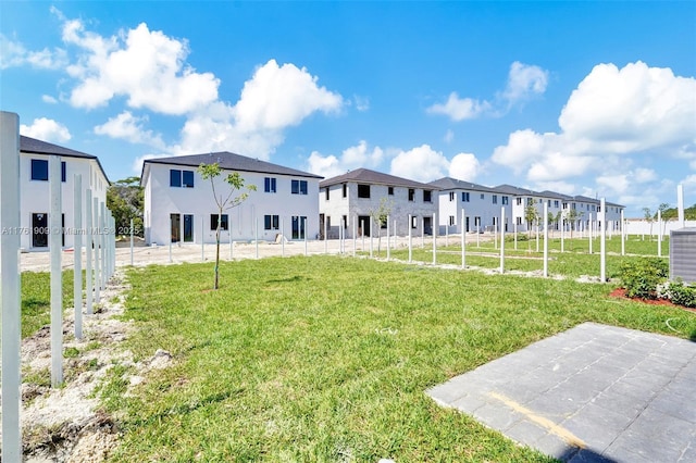 view of yard featuring fence and a residential view