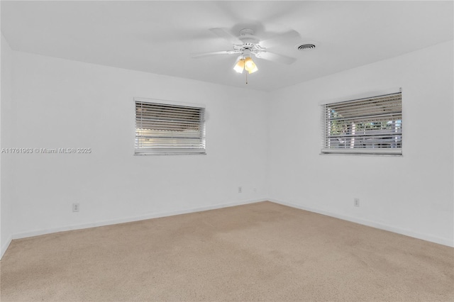 spare room featuring visible vents, baseboards, carpet, and ceiling fan