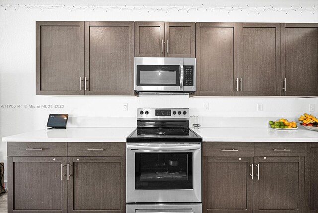 3489 W 110th Ter, Hialeah, FL 33018 - kitchen featuring dark brown cabinetry, a breakfast bar, open floor plan, light wood finished floors, and stainless steel appliances