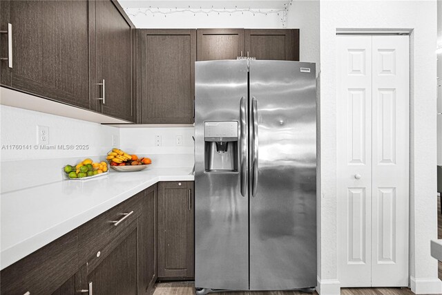 3489 W 110th Ter, Hialeah, FL 33018 - kitchen featuring dark brown cabinets, a sink, stainless steel appliances, light wood-type flooring, and visible vents