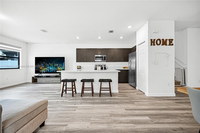3489 W 110th Ter, Hialeah, FL 33018 - kitchen with light countertops, dark brown cabinets, appliances with stainless steel finishes, and light wood-type flooring