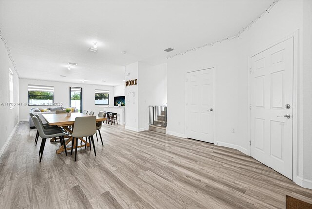 3489 W 110th Ter, Hialeah, FL 33018 - living room featuring visible vents and light wood-style flooring