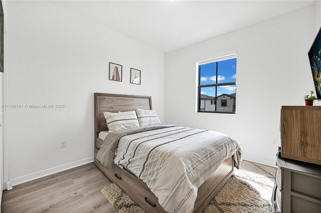 3489 W 110th Ter, Hialeah, FL 33018 - bedroom featuring baseboards and wood finished floors