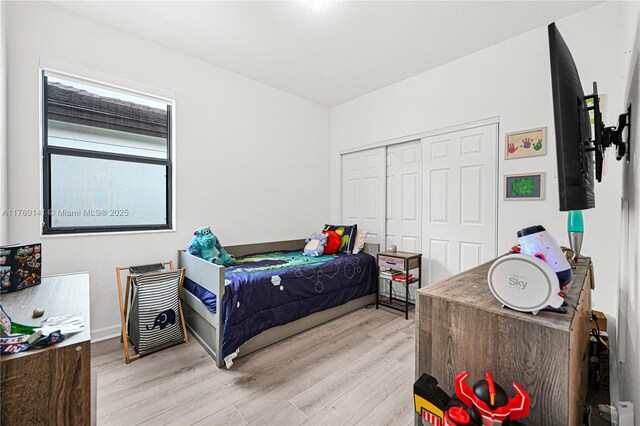 3489 W 110th Ter, Hialeah, FL 33018 - bedroom featuring baseboards, visible vents, light wood-style flooring, and a closet