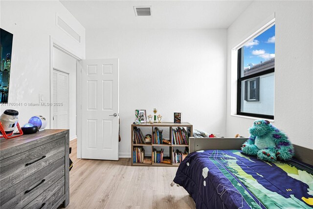 3489 W 110th Ter, Hialeah, FL 33018 - bedroom featuring baseboards and wood finished floors