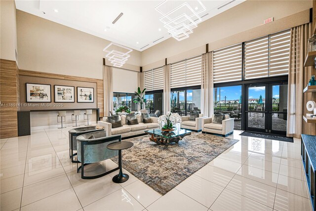 3489 W 110th Ter, Hialeah, FL 33018 - living room with french doors, a raised ceiling, baseboards, a chandelier, and recessed lighting