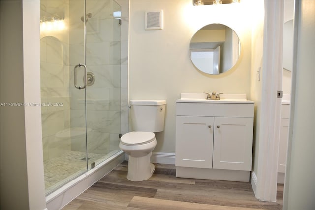 full bathroom with visible vents, a stall shower, toilet, and wood finished floors