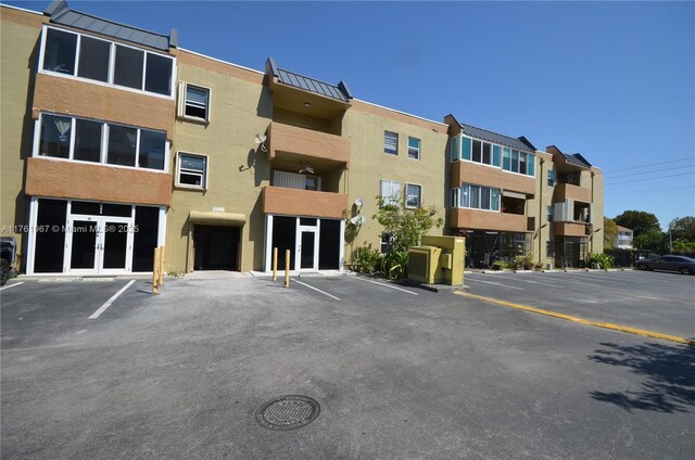 6070 W 18th Ave Unit 310, Hialeah, FL 33012 - view of apartment building / complex with uncovered parking