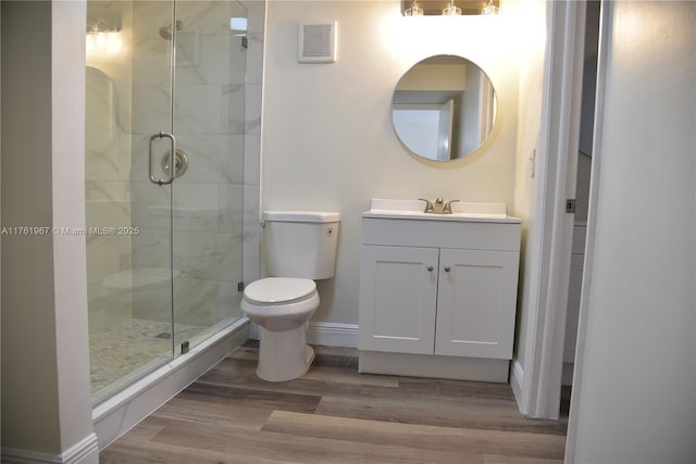 bathroom featuring visible vents, toilet, wood finished floors, and a shower stall