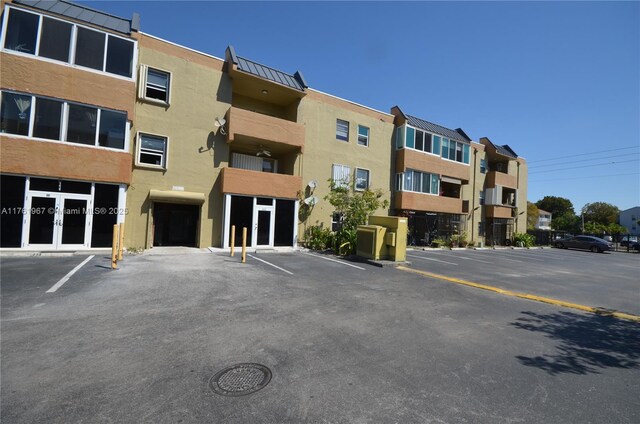 6070 W 18th Ave Unit 310, Hialeah, FL 33012 - view of apartment building / complex with uncovered parking