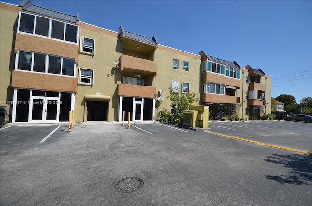 view of property featuring uncovered parking