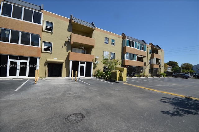 view of building exterior with uncovered parking