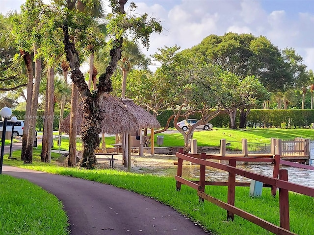 view of home's community with a gazebo, a lawn, and fence