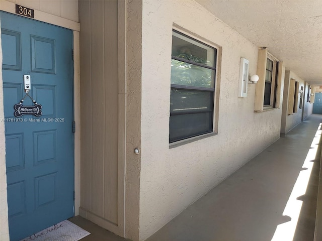 property entrance featuring stucco siding