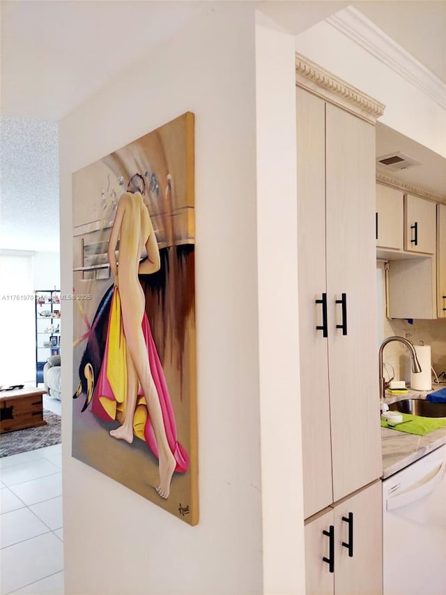 interior details featuring a sink, visible vents, ornamental molding, and white dishwasher