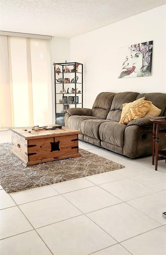 unfurnished living room featuring tile patterned floors and a textured ceiling