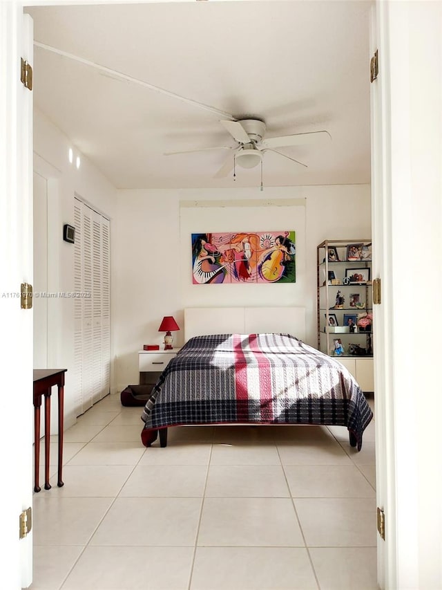 bedroom featuring tile patterned floors and a ceiling fan