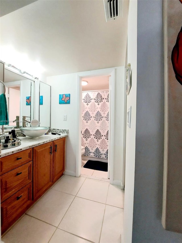 bathroom featuring tile patterned floors, visible vents, toilet, curtained shower, and vanity