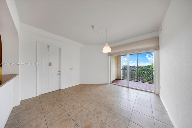 unfurnished room featuring baseboards and light tile patterned floors
