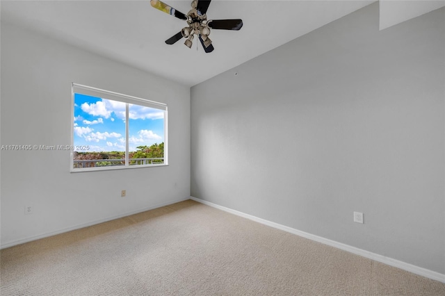 carpeted empty room with baseboards and a ceiling fan