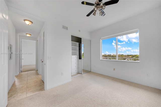 unfurnished bedroom featuring visible vents, ceiling fan, baseboards, and light carpet