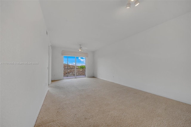 unfurnished room with a ceiling fan, light carpet, and baseboards