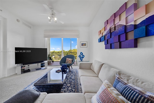 living room featuring visible vents, a ceiling fan, and carpet flooring