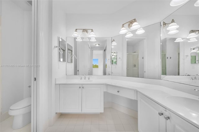 bathroom with a stall shower, toilet, tile patterned flooring, and double vanity