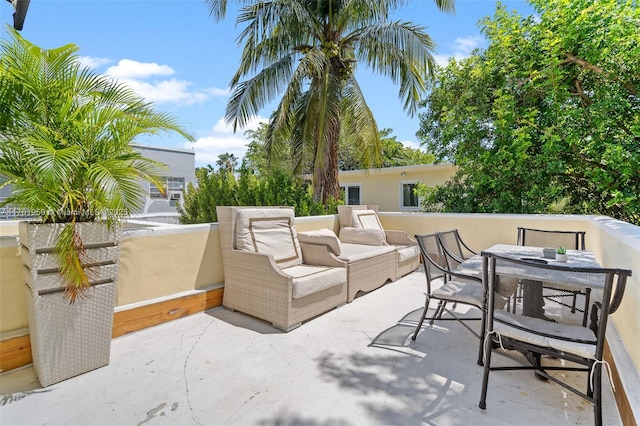 view of patio / terrace featuring a balcony, outdoor dining area, and an outdoor hangout area