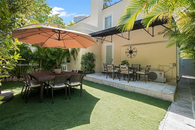 view of patio with ac unit and outdoor dining space