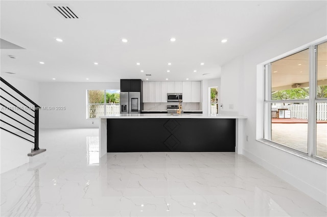 kitchen featuring recessed lighting, visible vents, appliances with stainless steel finishes, and white cabinets