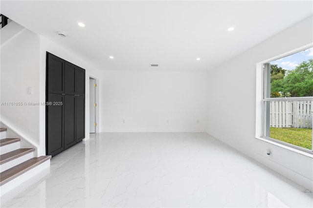 unfurnished room featuring recessed lighting, visible vents, marble finish floor, and stairs