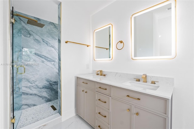 full bathroom with double vanity, marble finish floor, a marble finish shower, and a sink