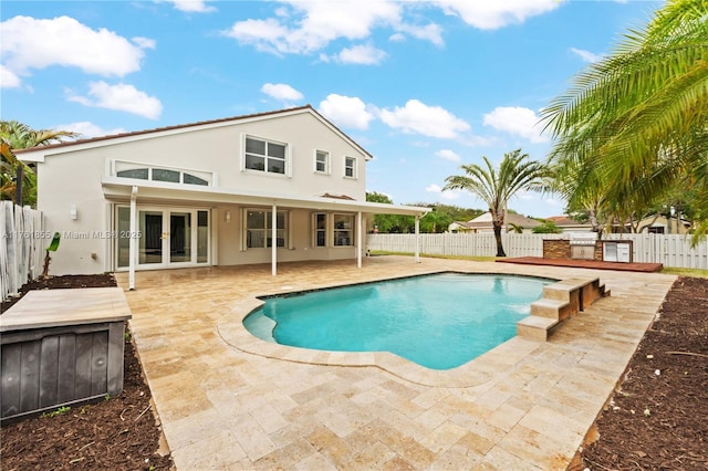 view of pool featuring a fenced in pool, a patio, a fenced backyard, and french doors